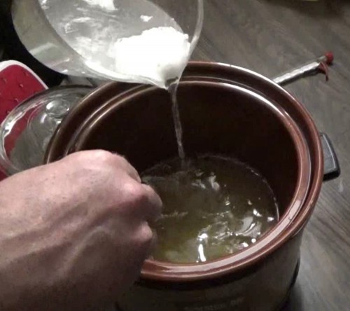 Pour lye and water mixture into the oil
