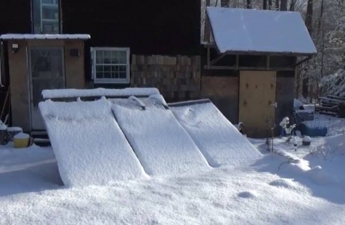 Sweeping fresh snow off the solar panels