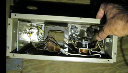 The original RV power converter box removed