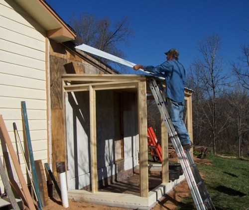 Putting on the roof tin Putting on the roof tin