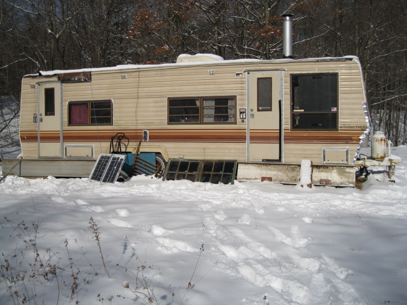 The off grid camper in a winter snow storm